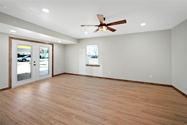 spare room featuring ceiling fan, french doors, and light hardwood / wood-style floors