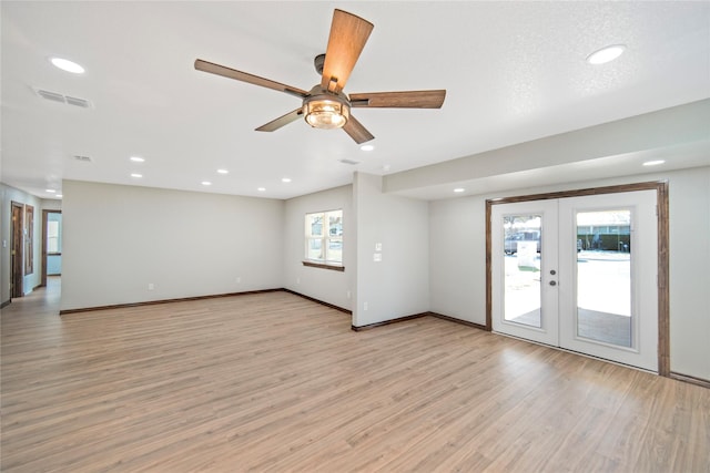 unfurnished room featuring french doors, ceiling fan, plenty of natural light, and light hardwood / wood-style floors