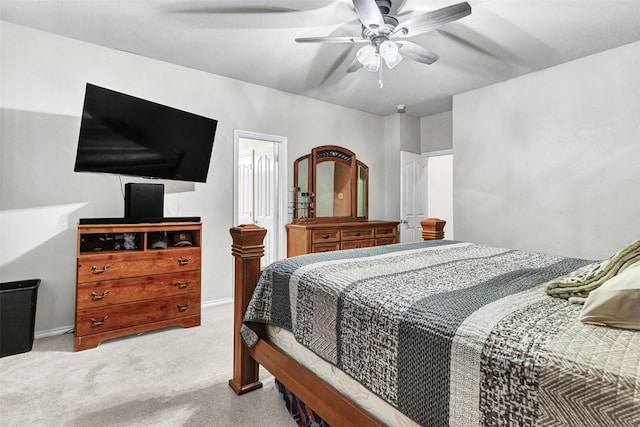 bedroom featuring ceiling fan and light carpet