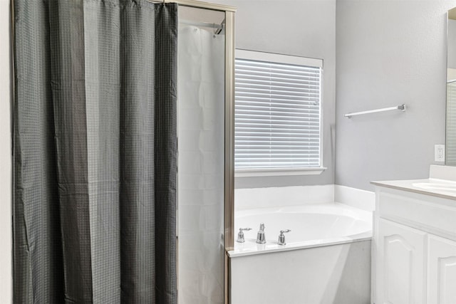 bathroom with vanity and shower with separate bathtub