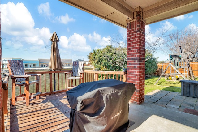 exterior space with a playground, a patio area, a lawn, and area for grilling