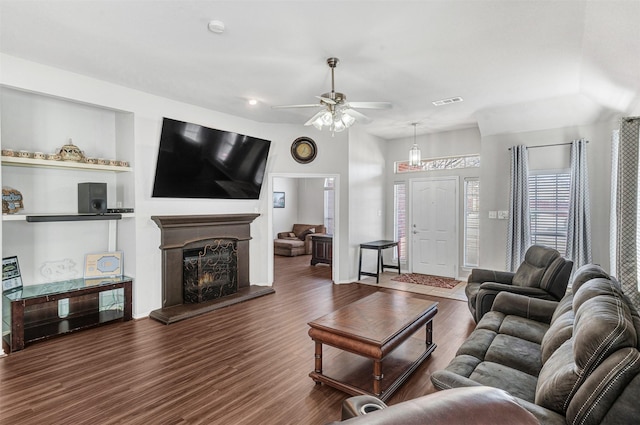 living room featuring ceiling fan and dark hardwood / wood-style floors