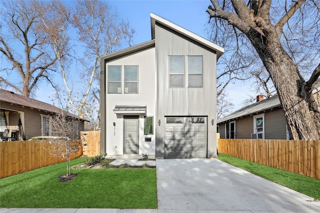 modern home featuring a front yard and a garage