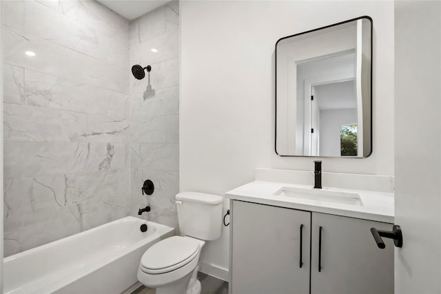 full bathroom featuring vanity, tiled shower / bath combo, and toilet