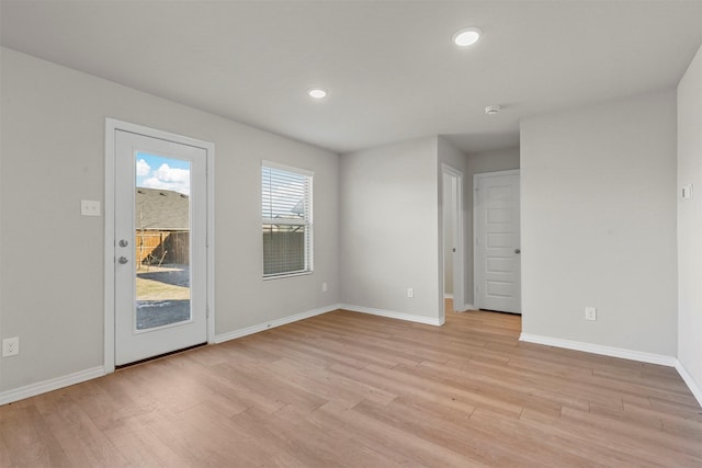 spare room with light hardwood / wood-style floors