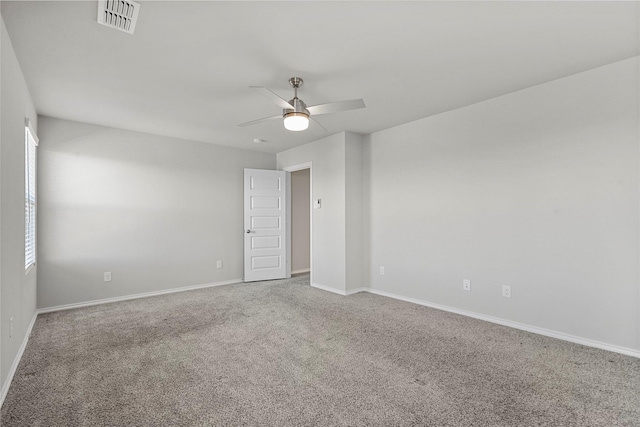 carpeted empty room featuring ceiling fan and a healthy amount of sunlight