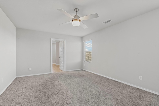 unfurnished room featuring ceiling fan and light carpet