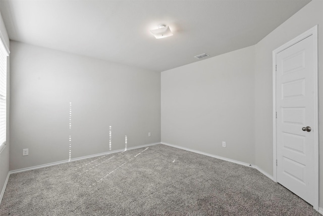 spare room featuring carpet floors and plenty of natural light