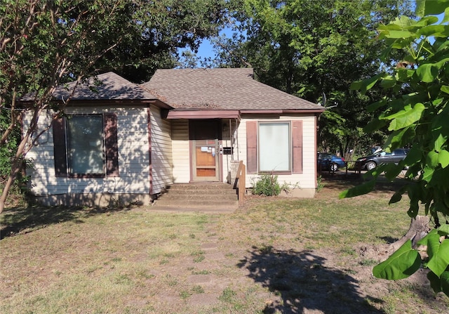 bungalow-style home featuring a front yard