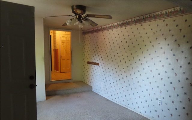 spare room with ceiling fan and carpet flooring