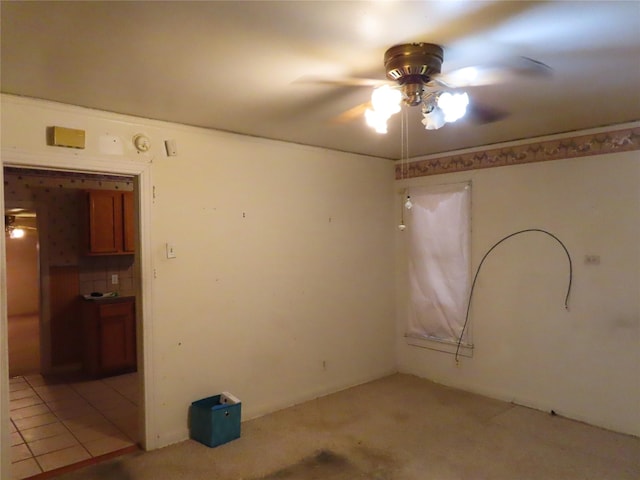 carpeted spare room featuring ceiling fan