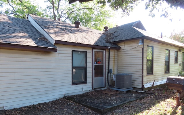 back of house featuring central AC unit