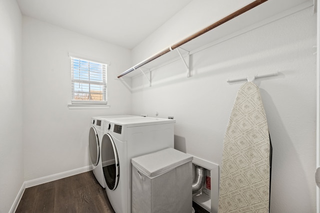 laundry area featuring washing machine and dryer and dark wood-type flooring