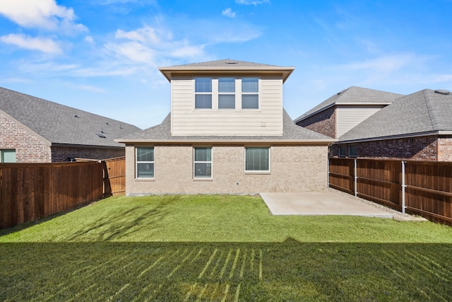 back of property with a lawn and a patio