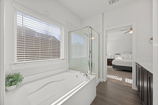 3912 Nature Ct, Denison, TX 75020 - ensuite bathroom with a shower stall, a garden tub, wood finished floors, vanity, and a ceiling fan