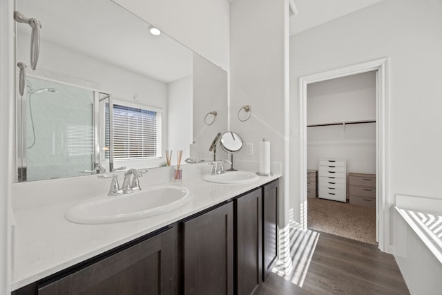 bathroom with hardwood / wood-style flooring, an enclosed shower, and vanity