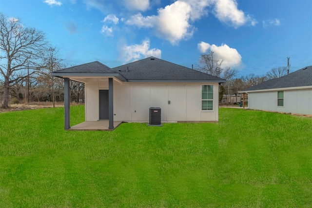 back of house featuring central AC, a yard, and a patio area