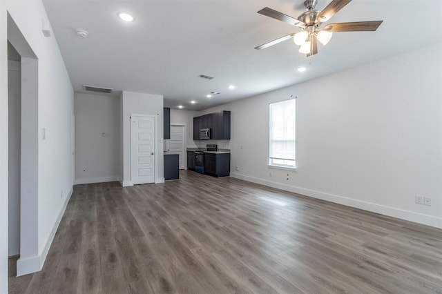 unfurnished living room featuring ceiling fan and wood-type flooring