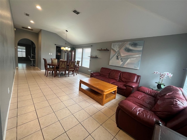 living area with lofted ceiling, light tile patterned flooring, and visible vents