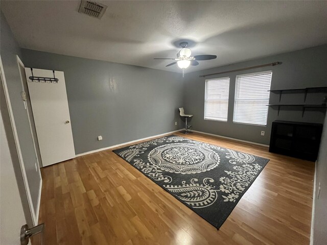 unfurnished room with ceiling fan and hardwood / wood-style floors