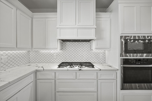 kitchen featuring white cabinetry, tasteful backsplash, and appliances with stainless steel finishes