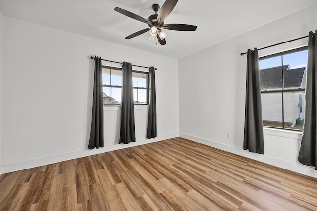 unfurnished room with ceiling fan, light hardwood / wood-style floors, and a wealth of natural light