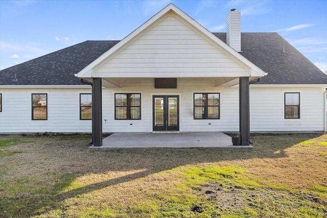 rear view of property with a patio area and a yard