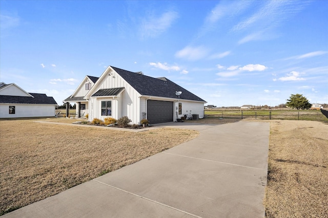 view of home's exterior with a garage and a yard