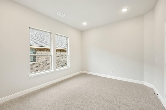 carpeted empty room featuring baseboards and recessed lighting