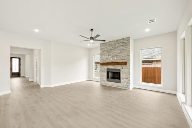 unfurnished living room with ceiling fan, a fireplace, light wood-style floors, baseboards, and recessed lighting