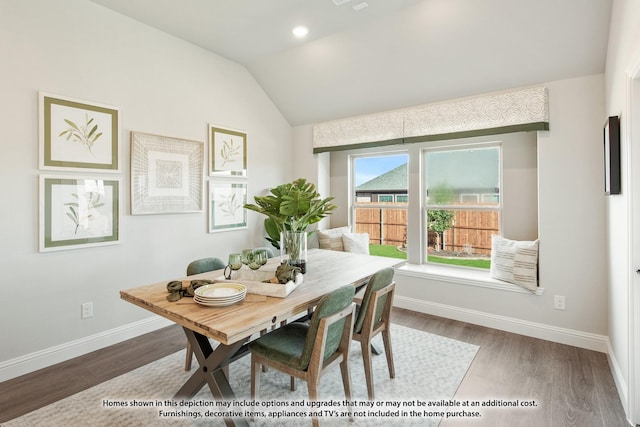 dining space featuring lofted ceiling and hardwood / wood-style flooring