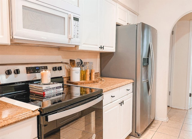 kitchen with stainless steel range with electric stovetop, white cabinets, and light tile patterned floors