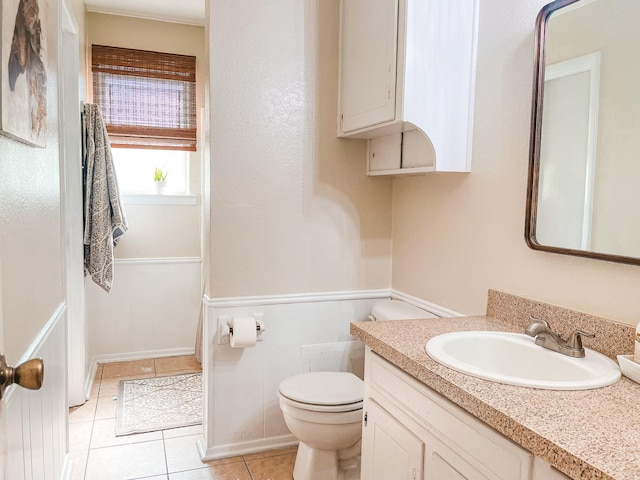 bathroom with tile patterned flooring, vanity, and toilet