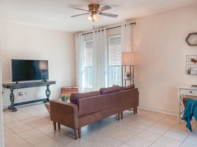 tiled living room with ceiling fan