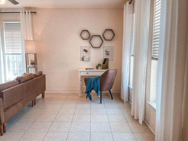 tiled home office featuring ceiling fan