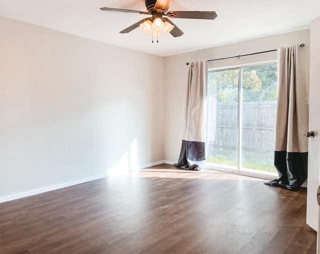 unfurnished room featuring ceiling fan and dark wood-type flooring