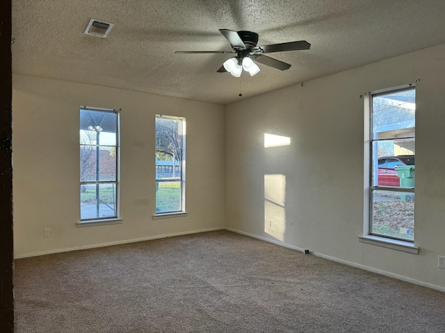 carpeted empty room with a textured ceiling and ceiling fan