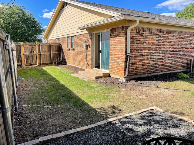 rear view of property featuring a lawn