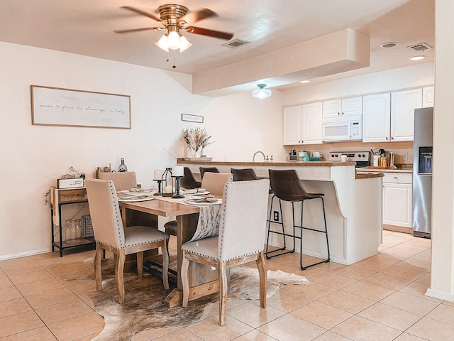 dining room featuring ceiling fan and light tile patterned floors