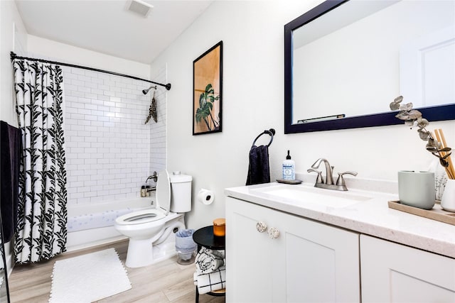 full bathroom featuring vanity, shower / tub combo with curtain, hardwood / wood-style flooring, and toilet