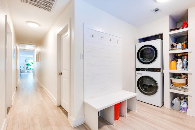 interior space featuring stacked washer and dryer and light hardwood / wood-style floors