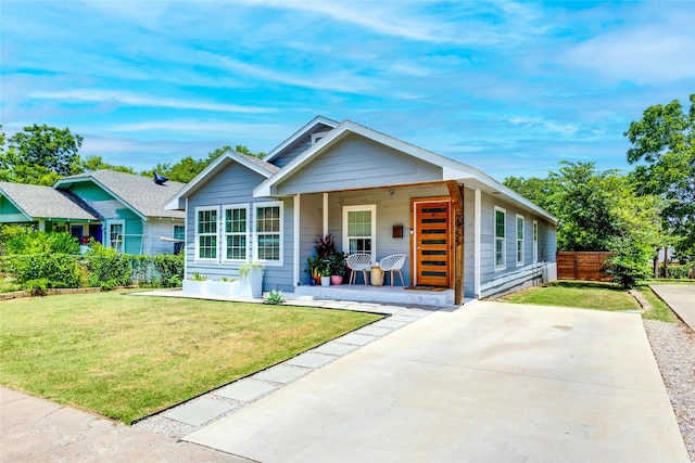 view of front of property featuring covered porch and a front lawn