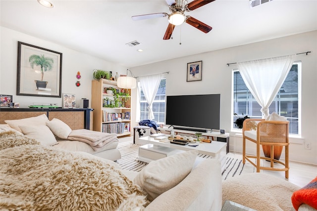 living room with a healthy amount of sunlight, ceiling fan, and light hardwood / wood-style floors