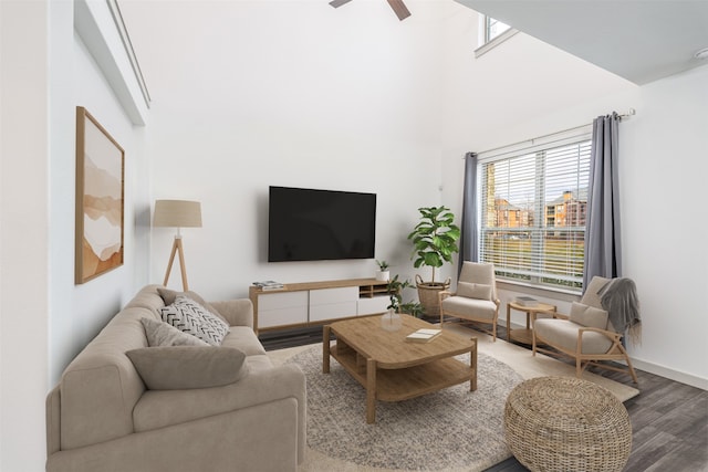 living room featuring ceiling fan, wood-type flooring, and plenty of natural light