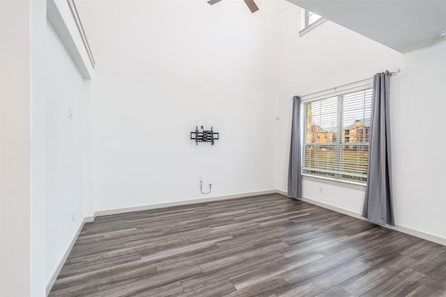 spare room with ceiling fan and dark hardwood / wood-style flooring