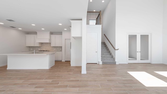 9328 Paintbrush Dr, Oak Point, TX 75068 - kitchen with backsplash, a sink, white cabinets, light countertops, and recessed lighting