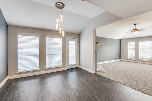 interior space featuring lofted ceiling, ceiling fan, and a healthy amount of sunlight