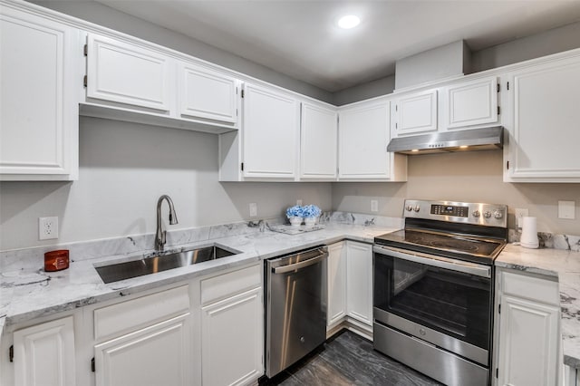 kitchen with light stone counters, dark hardwood / wood-style flooring, white cabinetry, appliances with stainless steel finishes, and sink