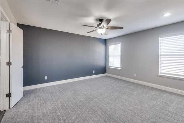 spare room featuring carpet floors and ceiling fan