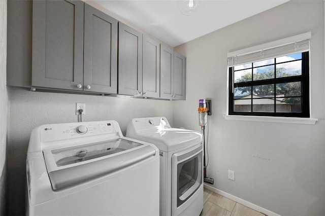 washroom with cabinets, light tile patterned flooring, and separate washer and dryer